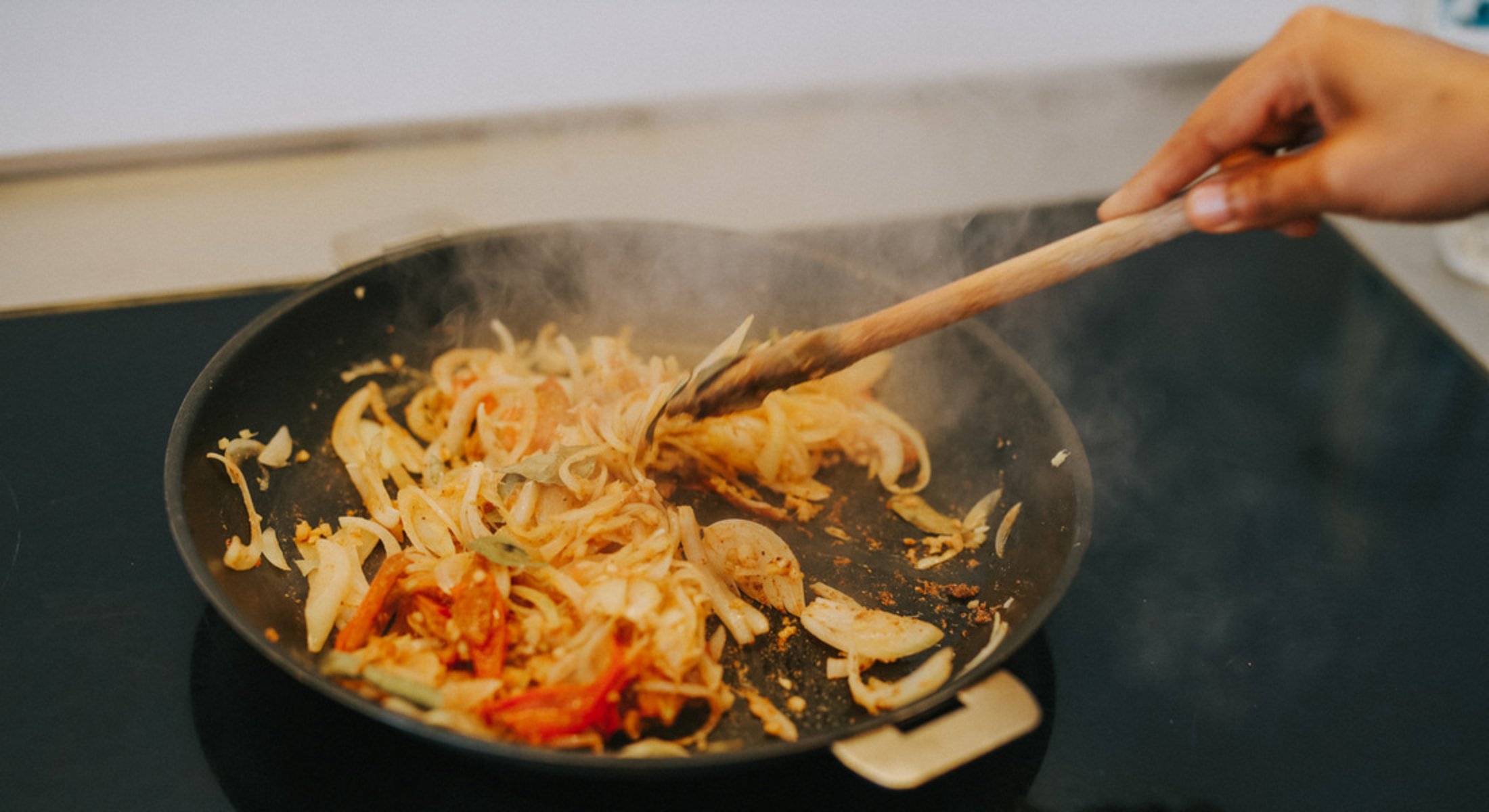 Photo de la cuisson dans une poêle d'une recette de poulet au garam masala